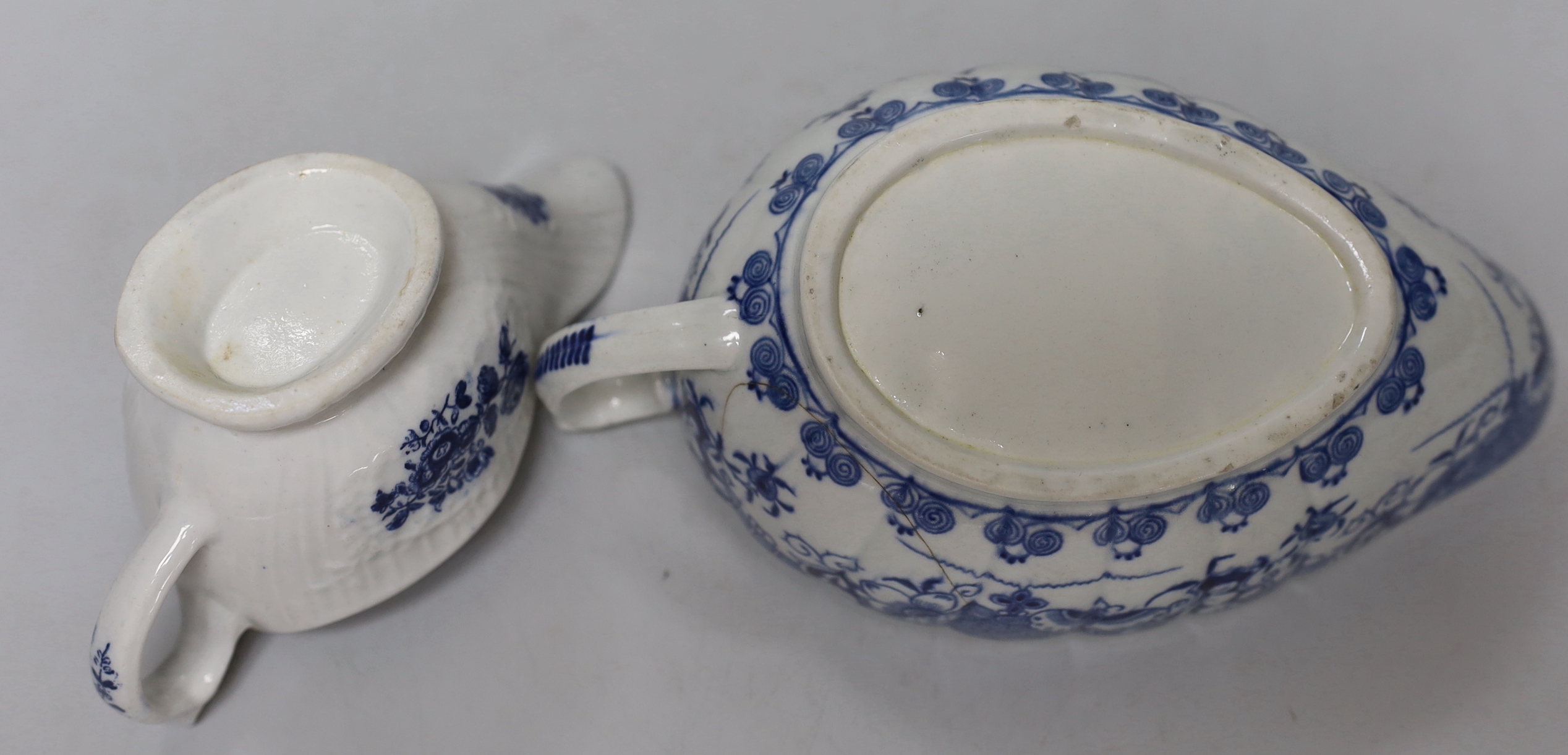 An 18th century Worcester blue and white cabbage-leaf mask jug, two similar sauceboats and an 18th century English blue and white sauceboat, a/f, tallest 19cm high